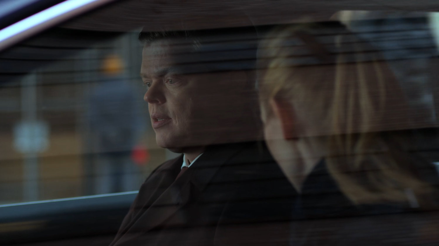 Karen and Foggy talking in a car parked on the street.