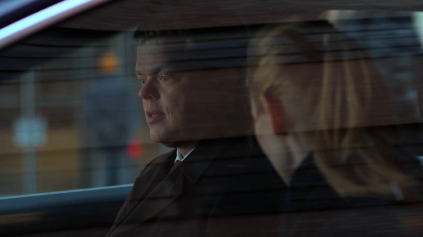 Karen and Foggy talking in a car parked on the street.