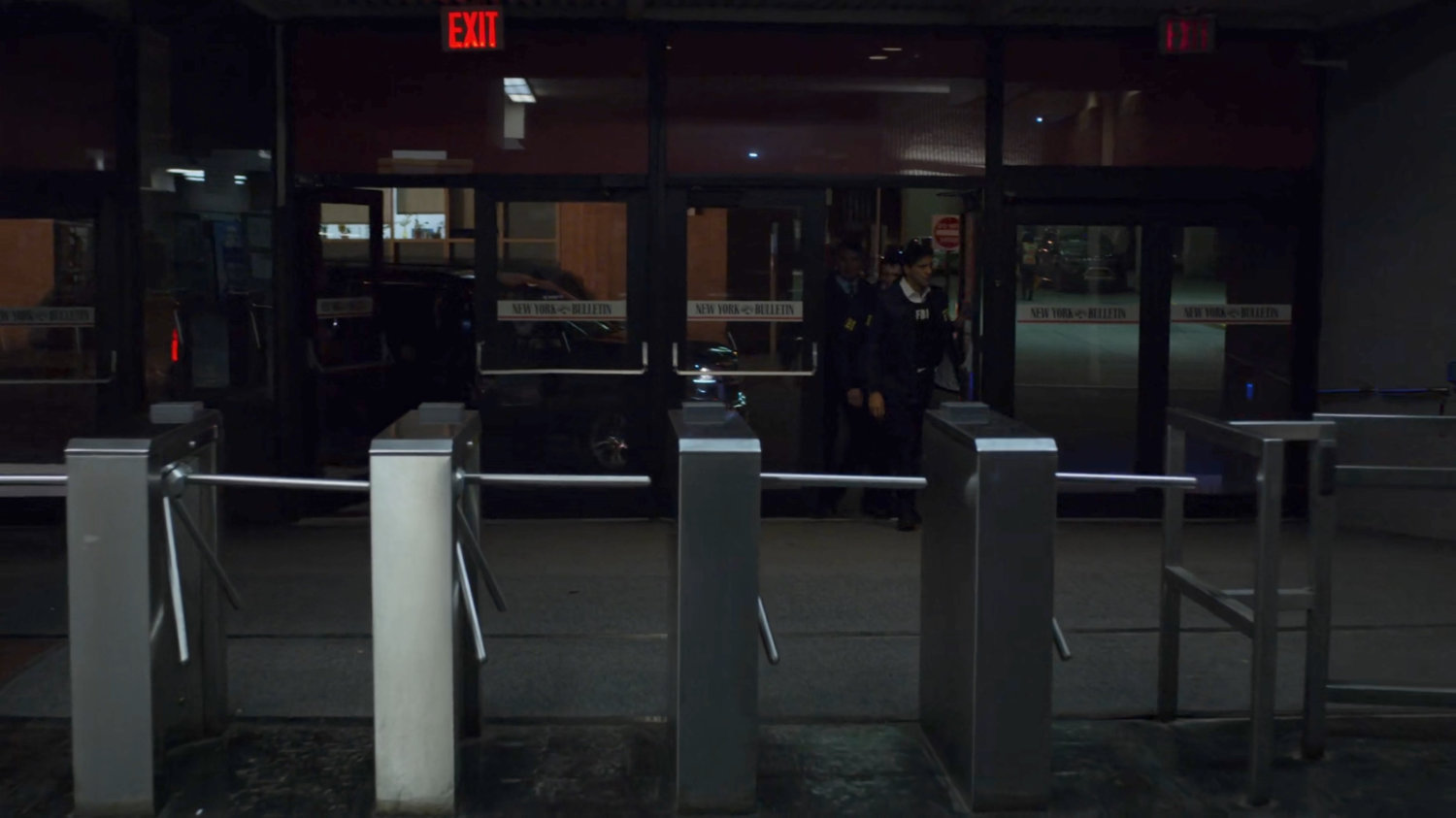 The FBI enter the New York Bulletin lobby.