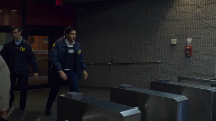 Agent Nadeem runs through the New York Bulletin lobby.