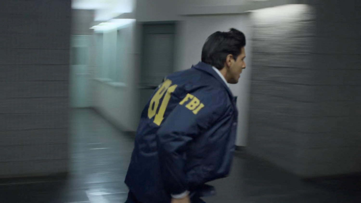 Agent Nadeem runs through the New York Bulletin lobby.