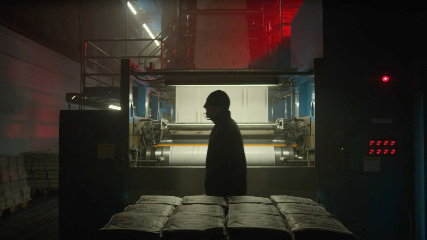 Matt walks through the printing press area of the New York Bulletin.