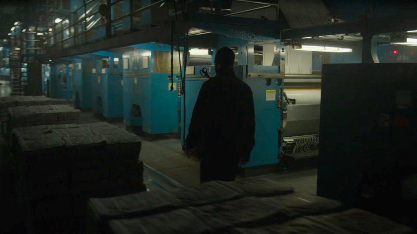 Matt walks through the printing press area of the New York Bulletin.