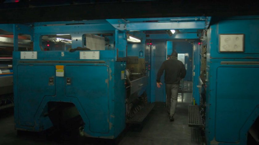 Matt walks through the printing press area of the New York Bulletin.