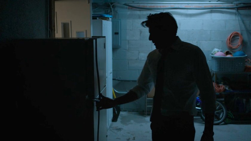 Ray Nadeem opening his basement refrigerator.