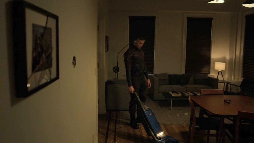 Dex vacuuming his apartment.