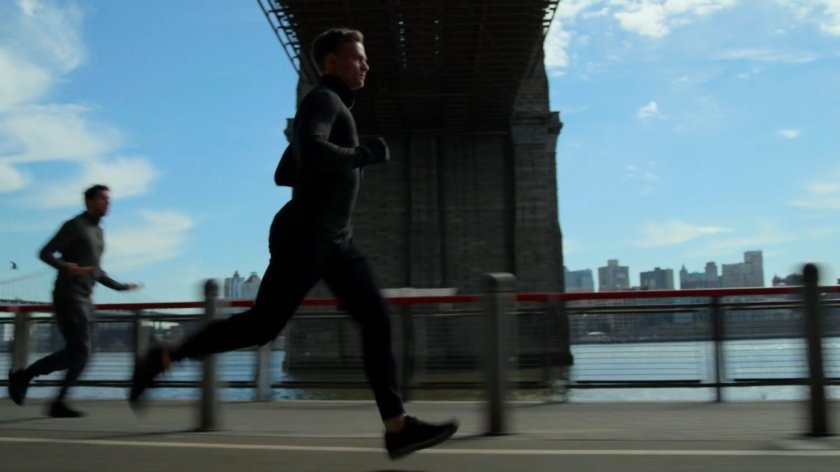 Dex on the jogging path under FDR drive, with the Brooklyn Bridge in the background.
