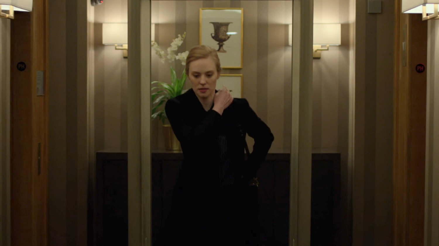 Karen passing through metal detector outside Fisk's penthouse in the Presidential Hotel.