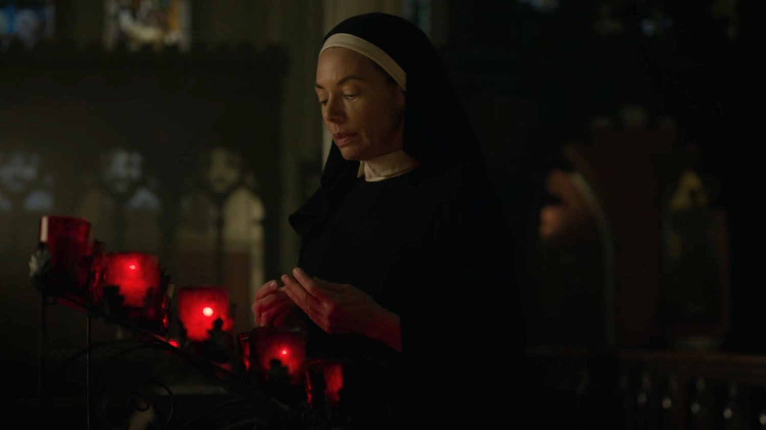 Maggie lighting a candle in Clinton Church.