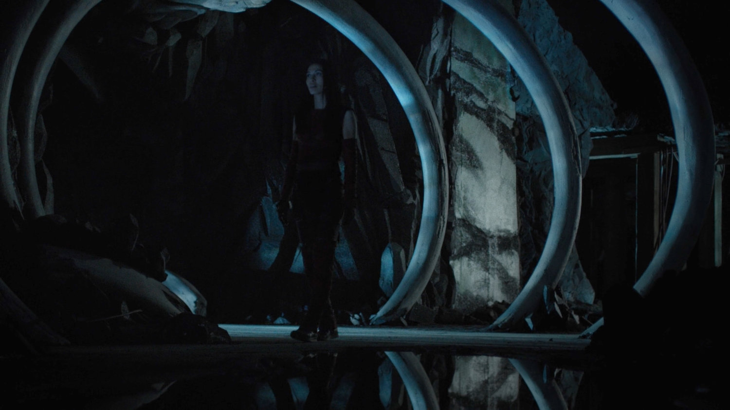 Elektra in an unearthed cave with fossilized dragon bones under Midland Circle.