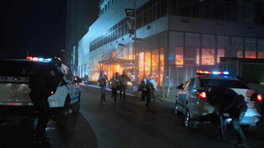 The Defenders run from the Midland Circle building as it begins to explode.