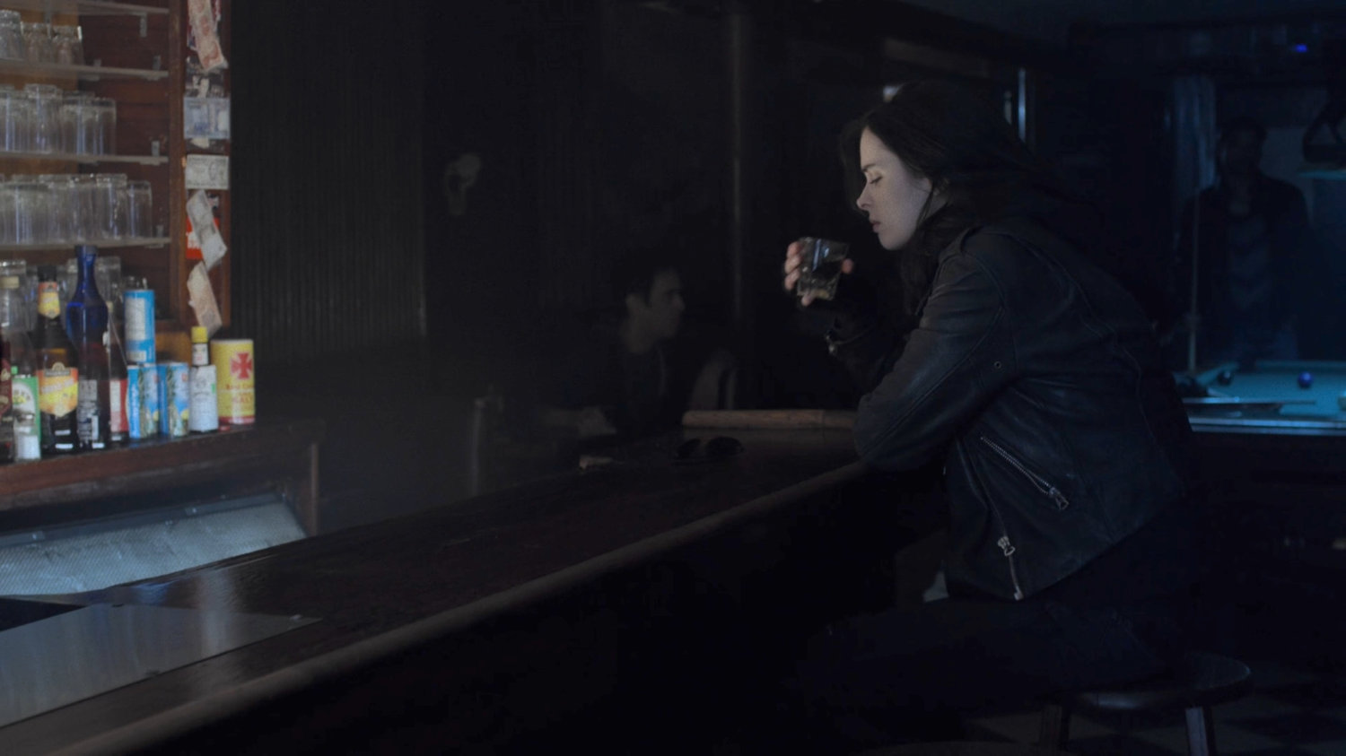 Jessica drinking in a bar.