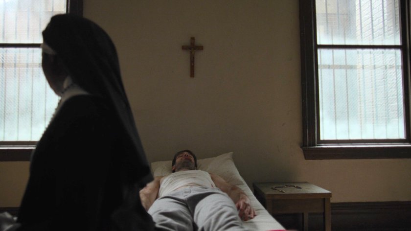 Matt lies unconscious in an orphanage by a nun.