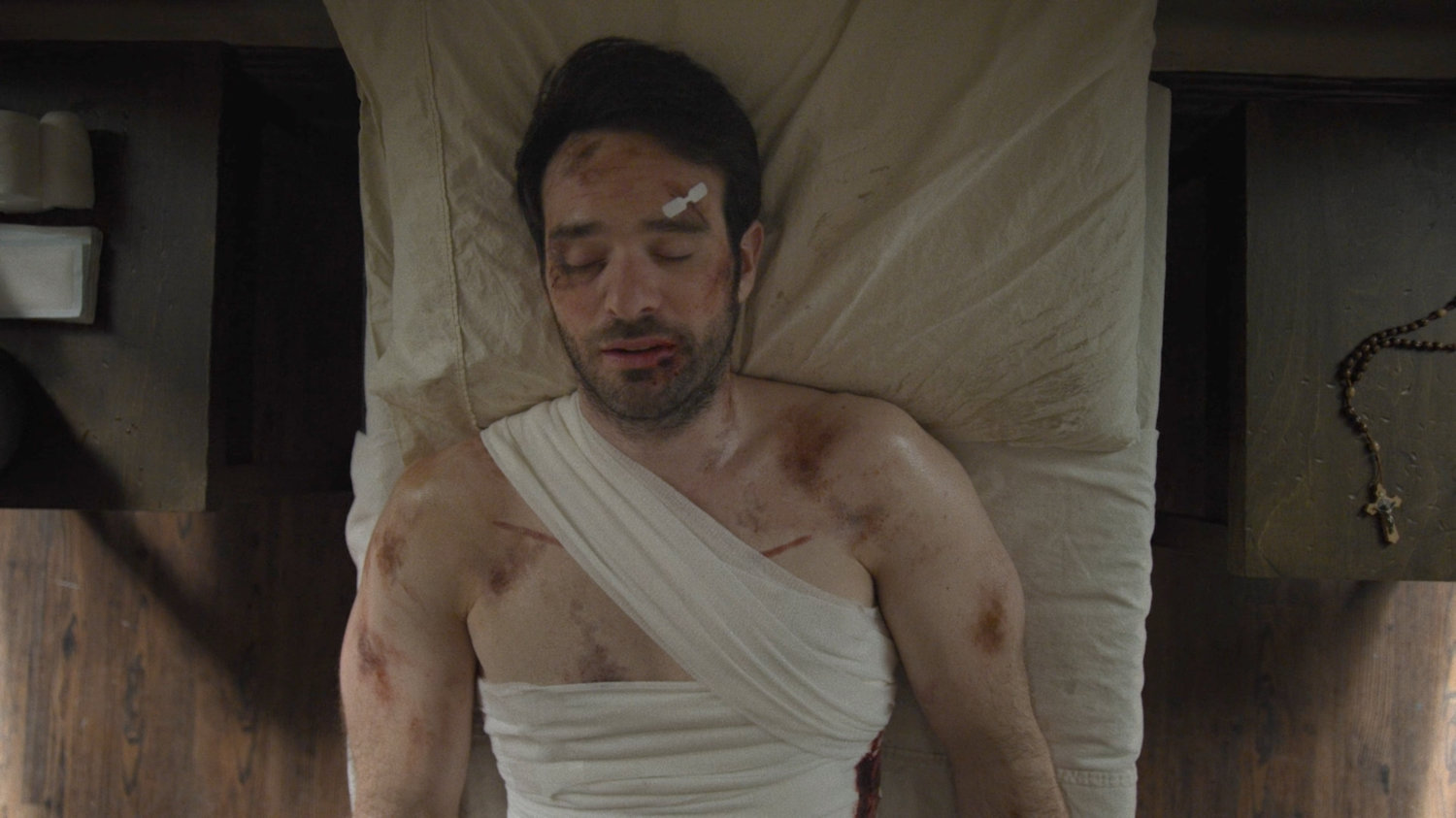 Matt lies unconscious in a bed at an orphanage.