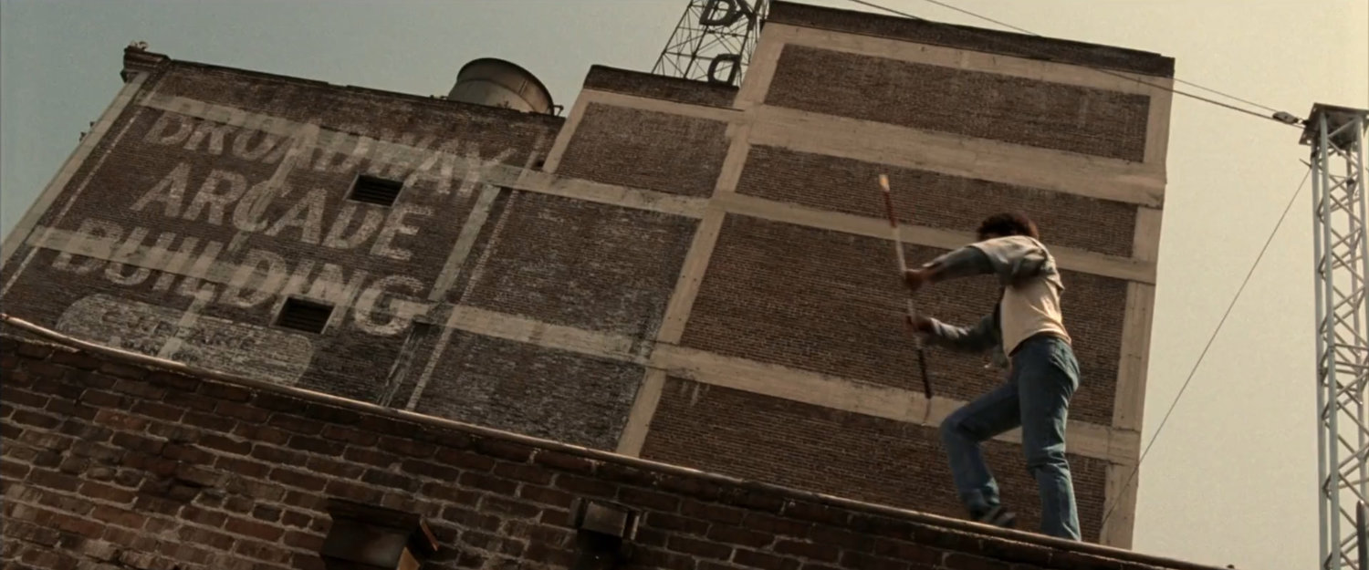 Young Matt practices acrobatics on rooftop of Murdock apartment building.