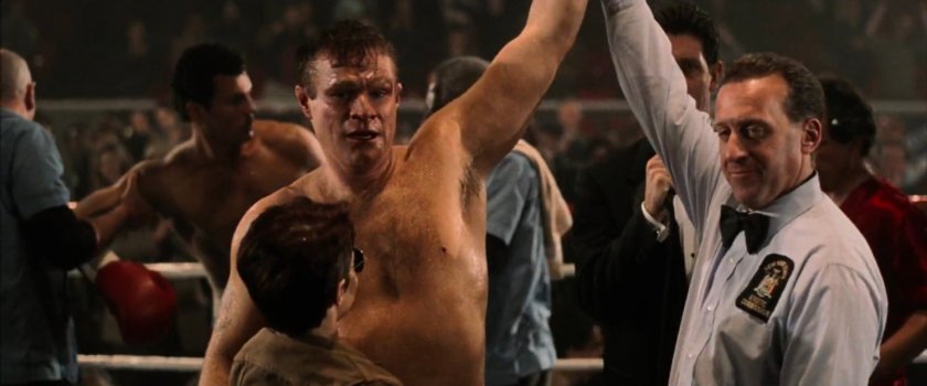 Referee holds up Jack Murdock's hand after a boxing match at the Olympic Auditorium.