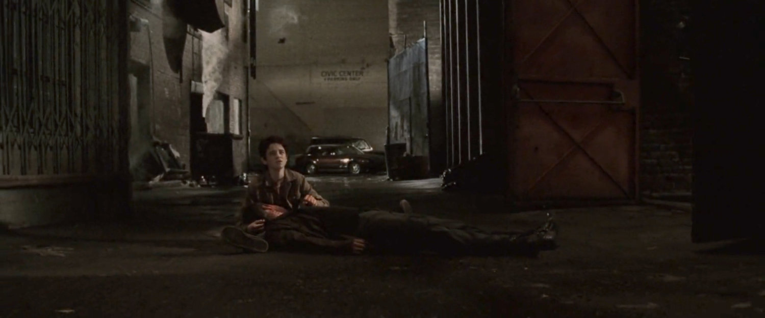 Young Matt cradles his dead father's body in an alley outside the Olympic Auditorium.