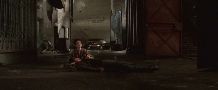 Young Matt cradles his dead father's body in an alley outside the Olympic Auditorium.