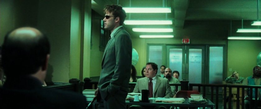 Matt and Foggy in a small civic courtroom.
