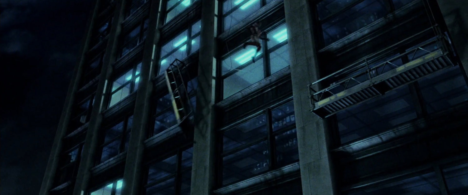 Daredevil leaps between scaffolding on a skyscraper at night.