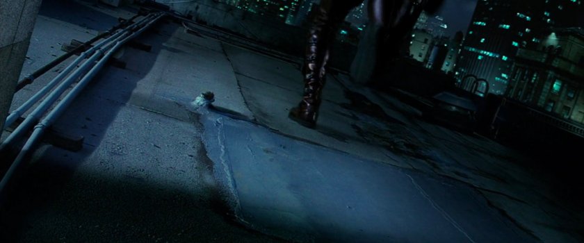 Daredevil running across rooftop at night.