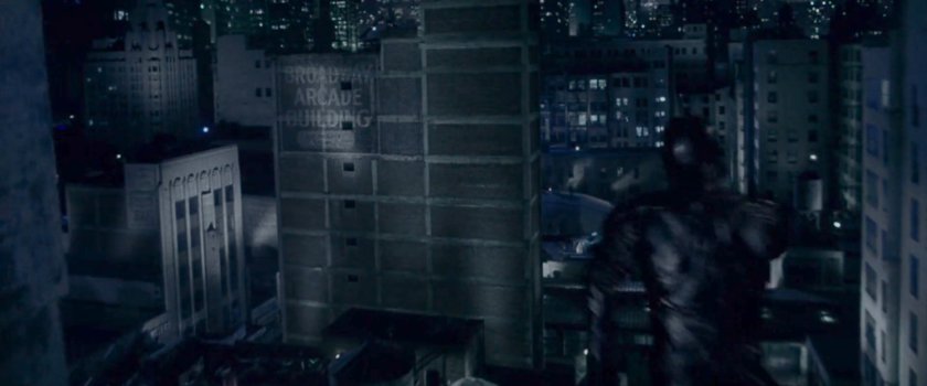 Daredevil leaping from rooftop to rooftop at night.