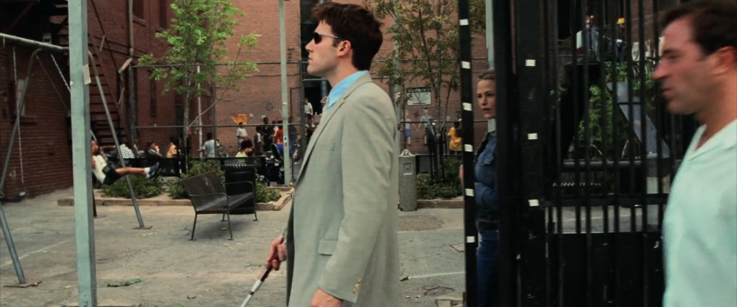 Matt on a sidewalk outside a New York playground.