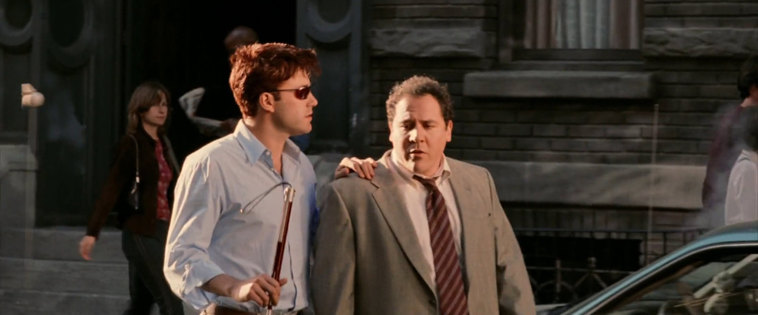 Matt and Foggy walking along a New York sidewalk.