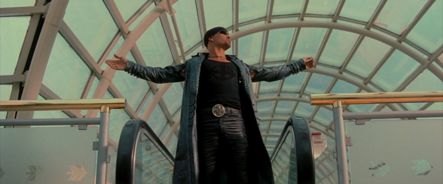 Bullseye exiting an escalator at an airport.
