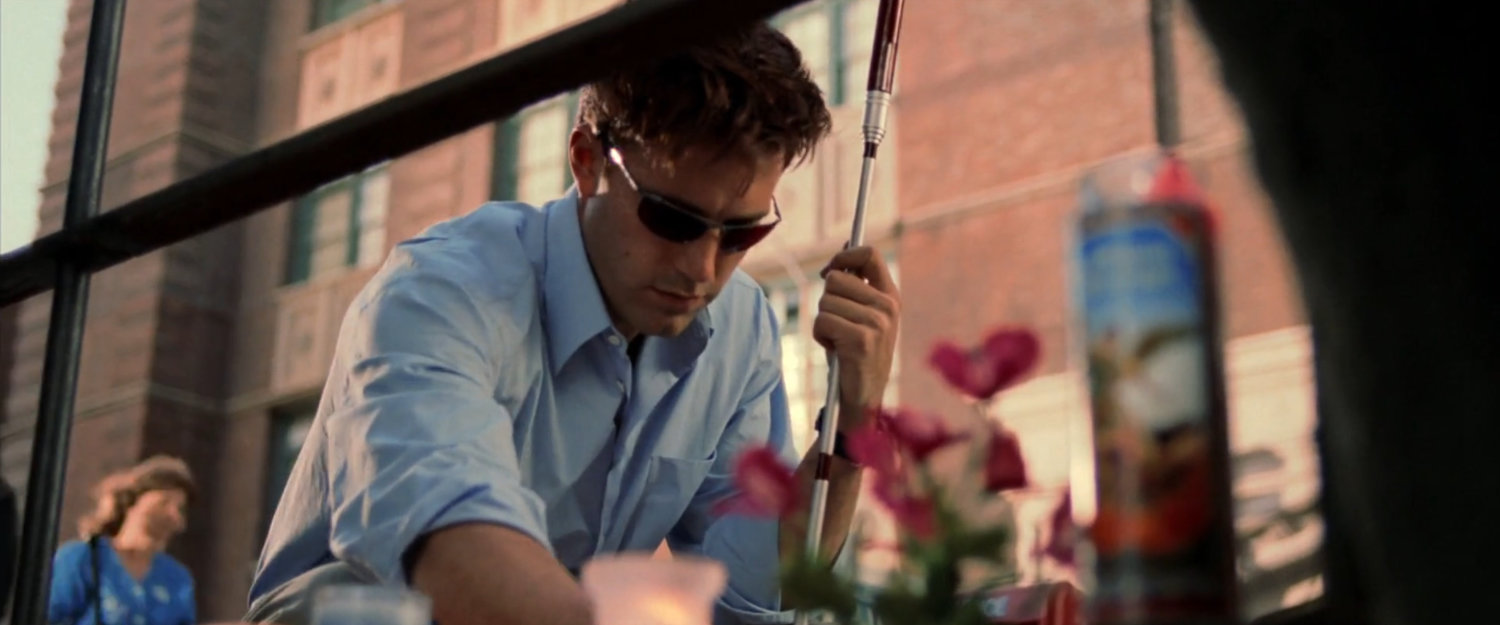 Matt squats outside Lisa Tazio's apartment.