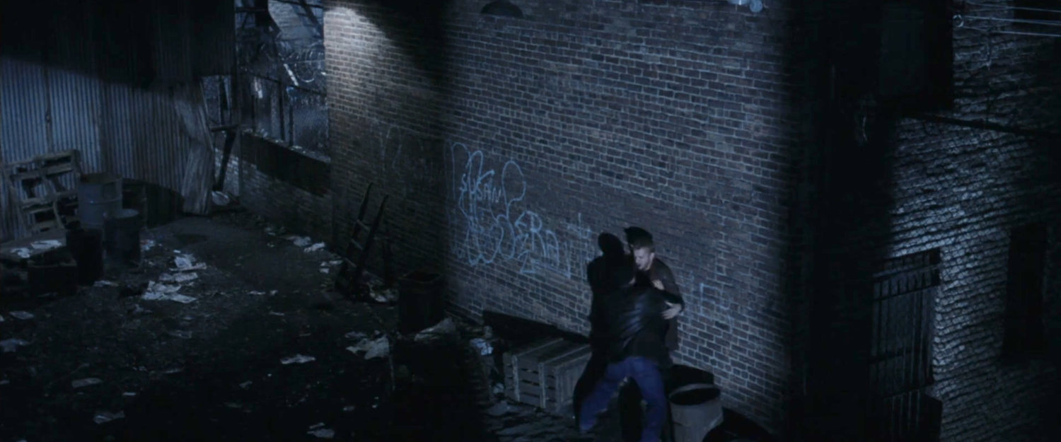 Man beating someone up in an alley.