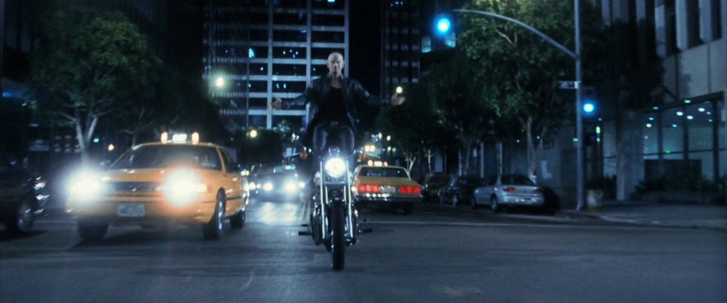 Bullseye standing on motorcycle on New York street.