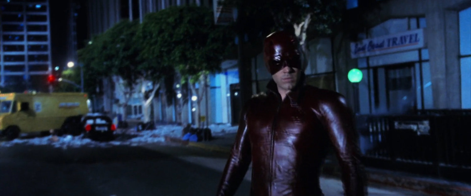 Daredevil standing in a New York street.