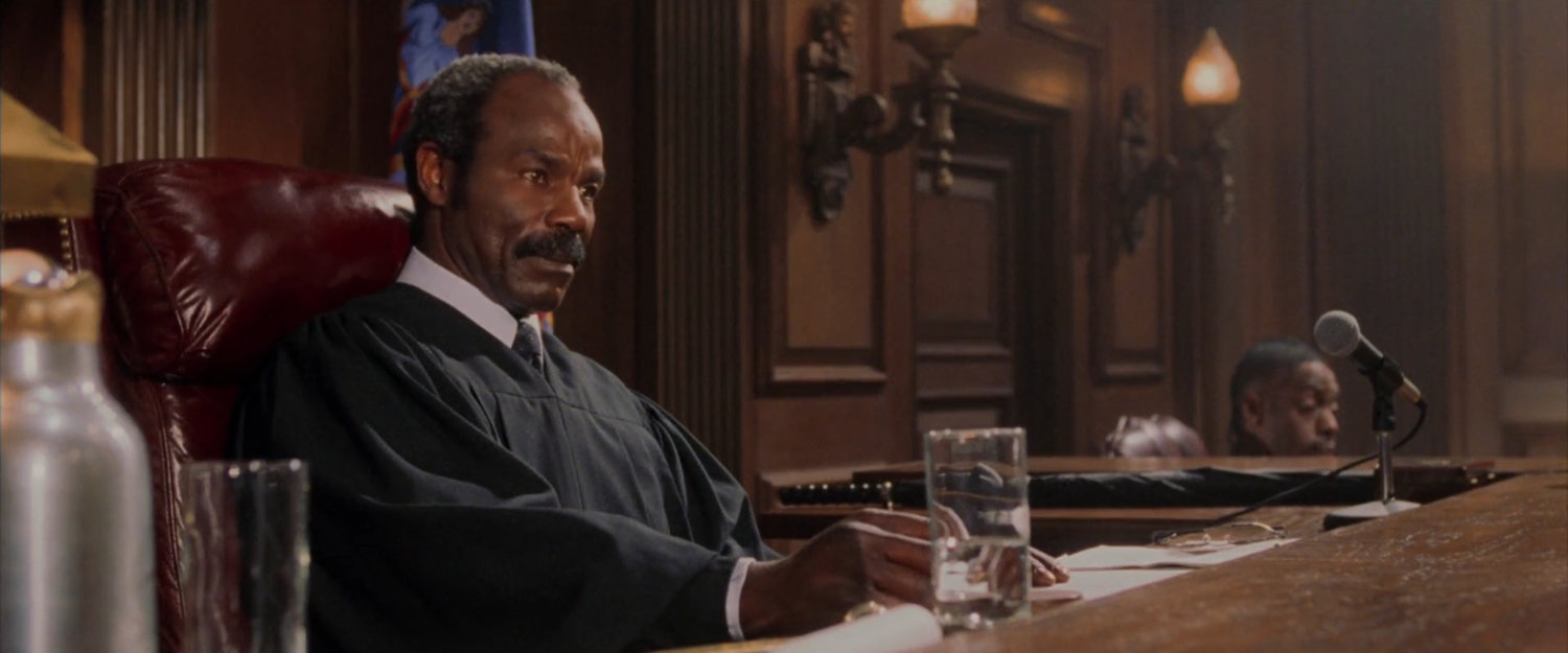 The judge in a courtroom.