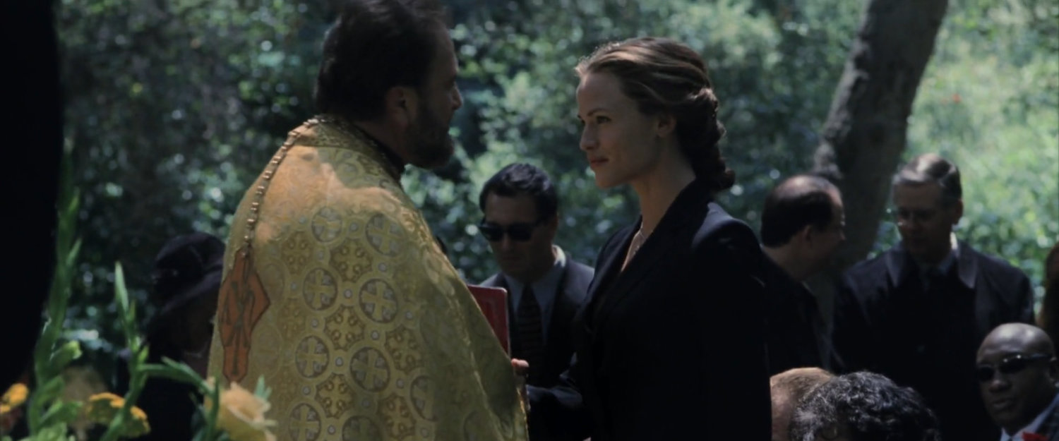 Elektra and priest at a cemetery.