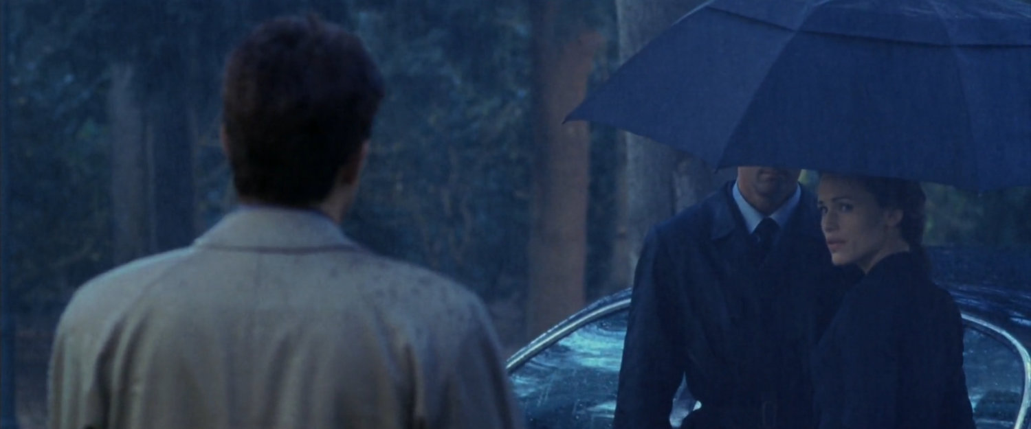 Elektra and Matt at a cemetery in the rain.