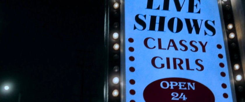 Sign outside a topless bar.