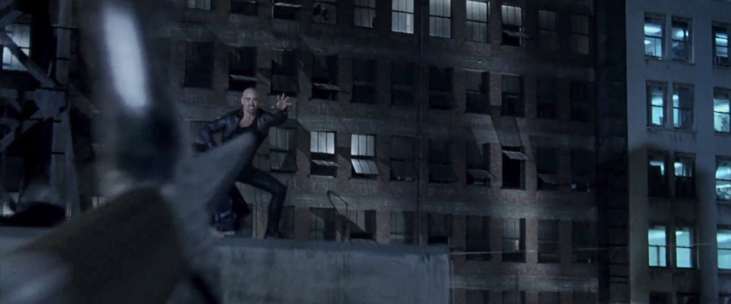 Bullseye readies to catch a thrown sai on a dark rooftop.