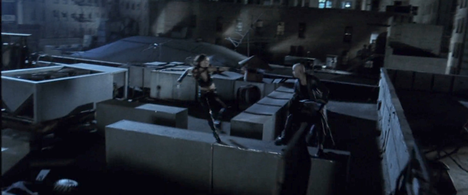 Elektra leaping towards Bullseye on a rooftop.