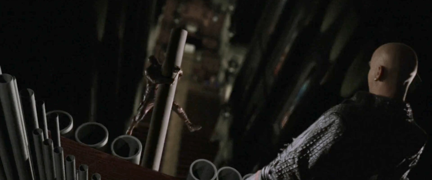 Bullseye watching Daredevil hang from an organ pipe in the Church of the Holy Innocents.