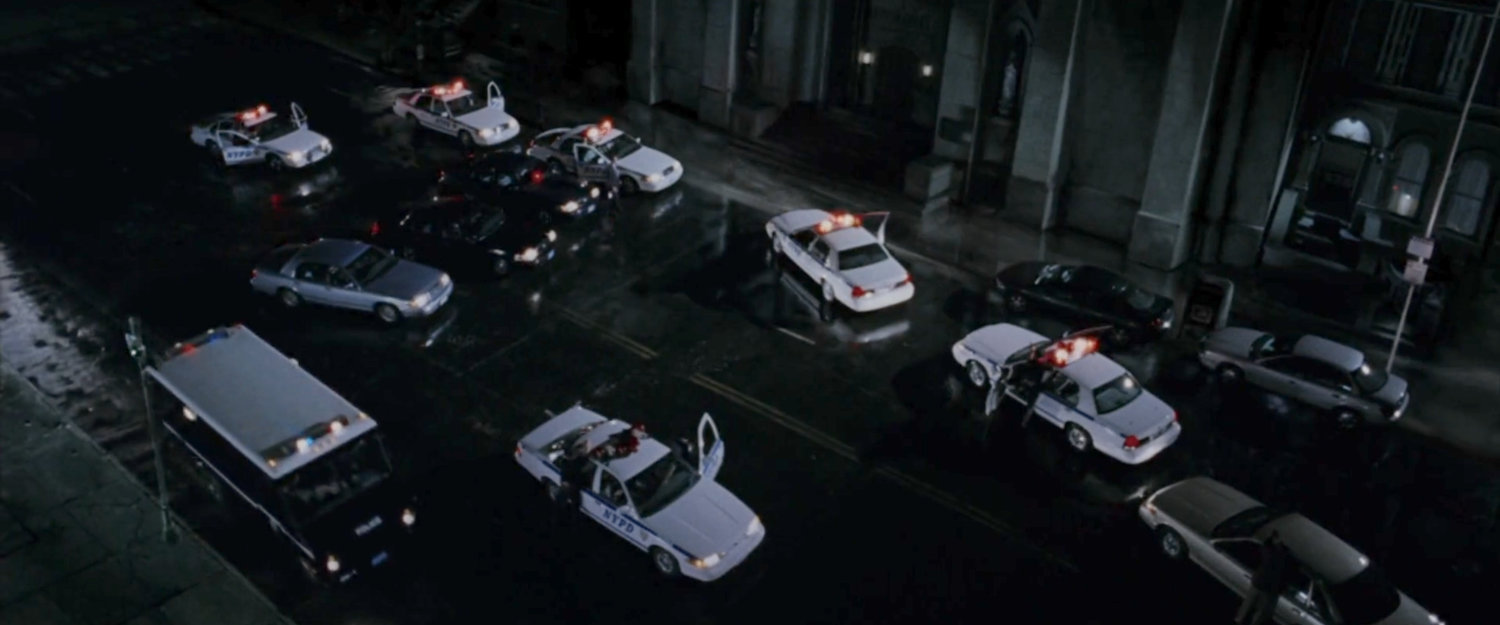 Police cars lined up outside the Church of the Holy Innocents.