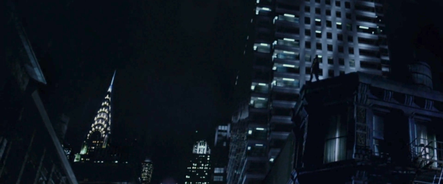 Daredevil standing on a rooftop ledge with Chrysler building in background.