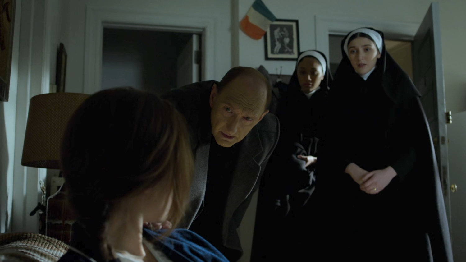Father Lantom comes for Maggie at her apartment.