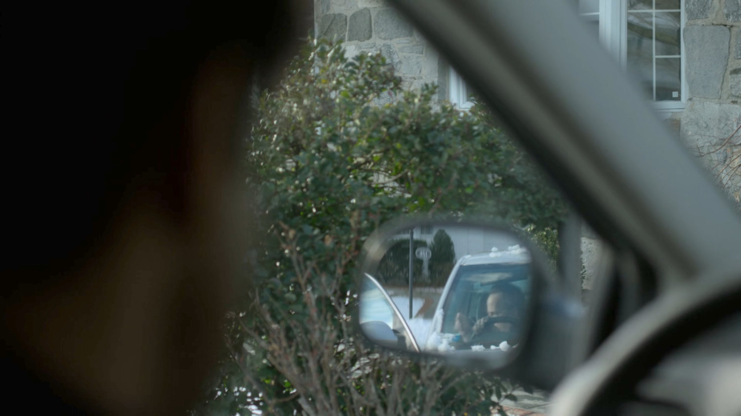 Ray Nadeem looking at side view mirror in front of SAC Hattley's house.