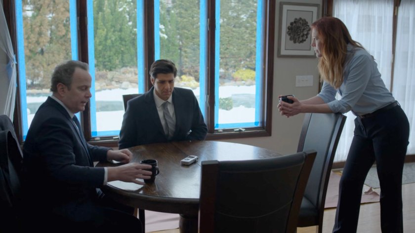 Agent Winn, Nadeem, and SAC Hattley around her kitchen table.