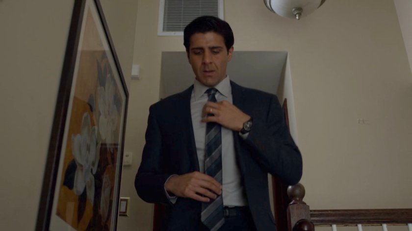 Agent Nadeem descends the stairs in his house.