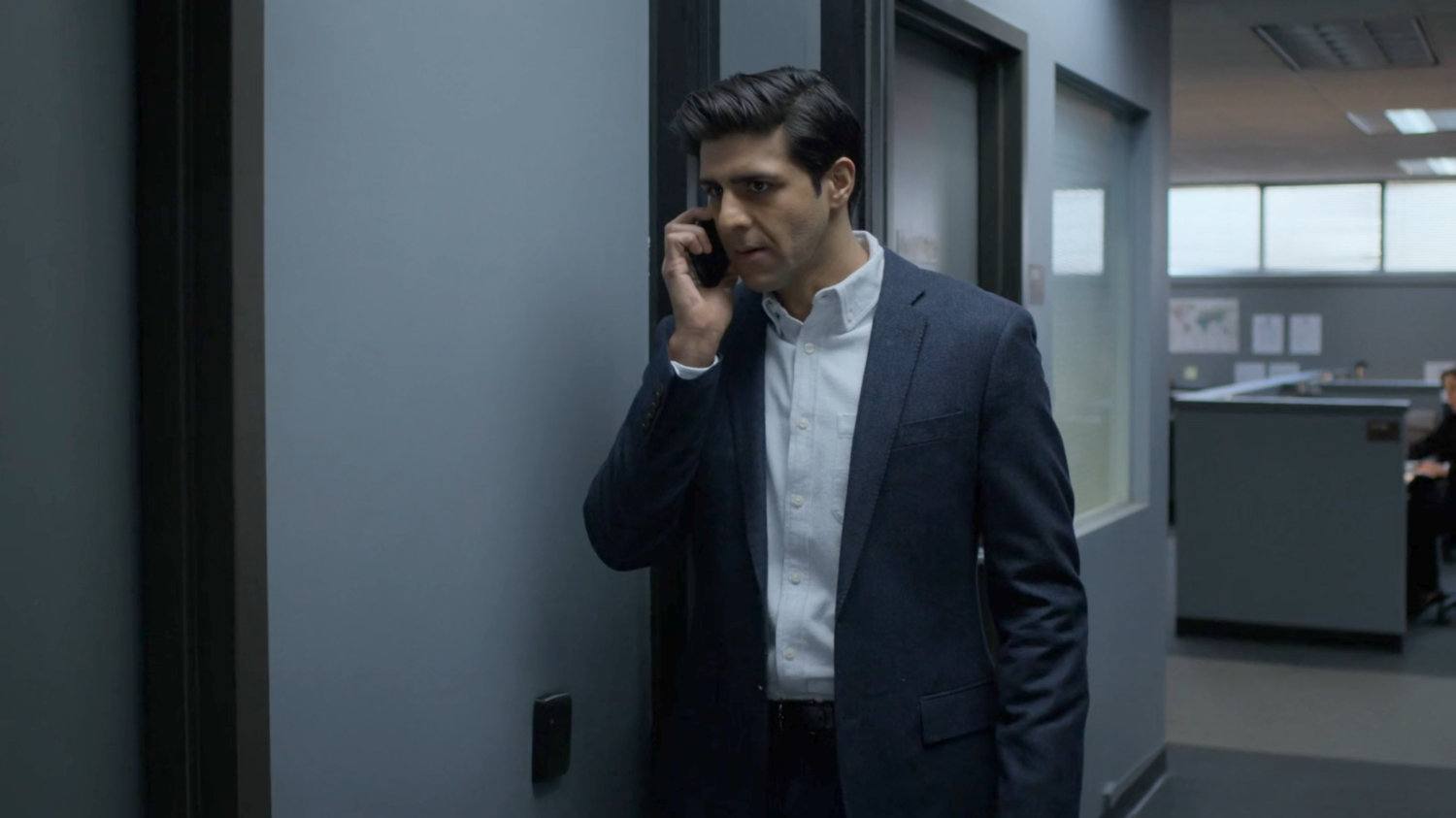 Agent Nadeem on the phone in the FBI offices.