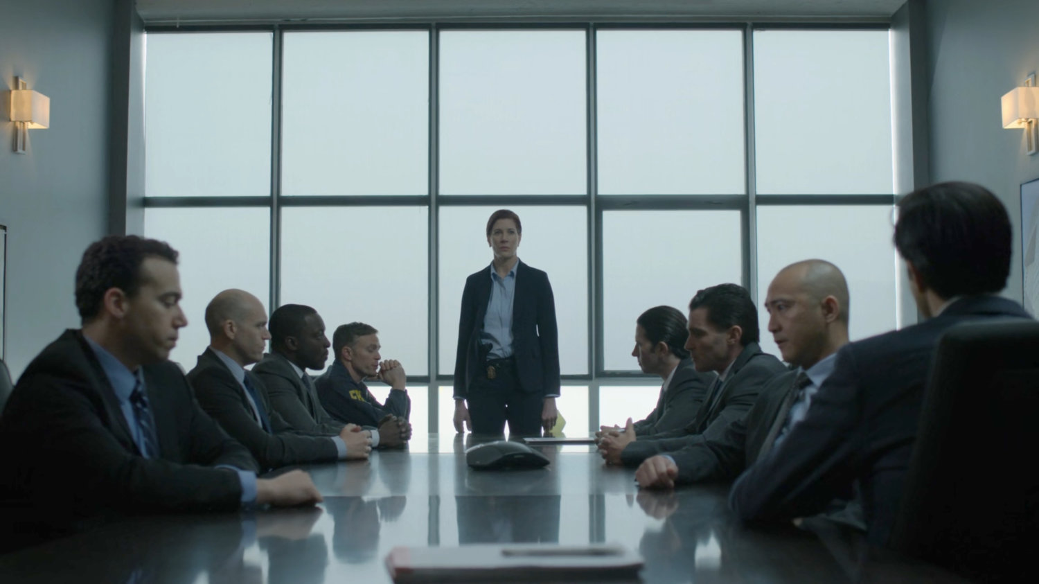 SAC Hattley stands by the eight corrupted Agents in the FBI meeting room.