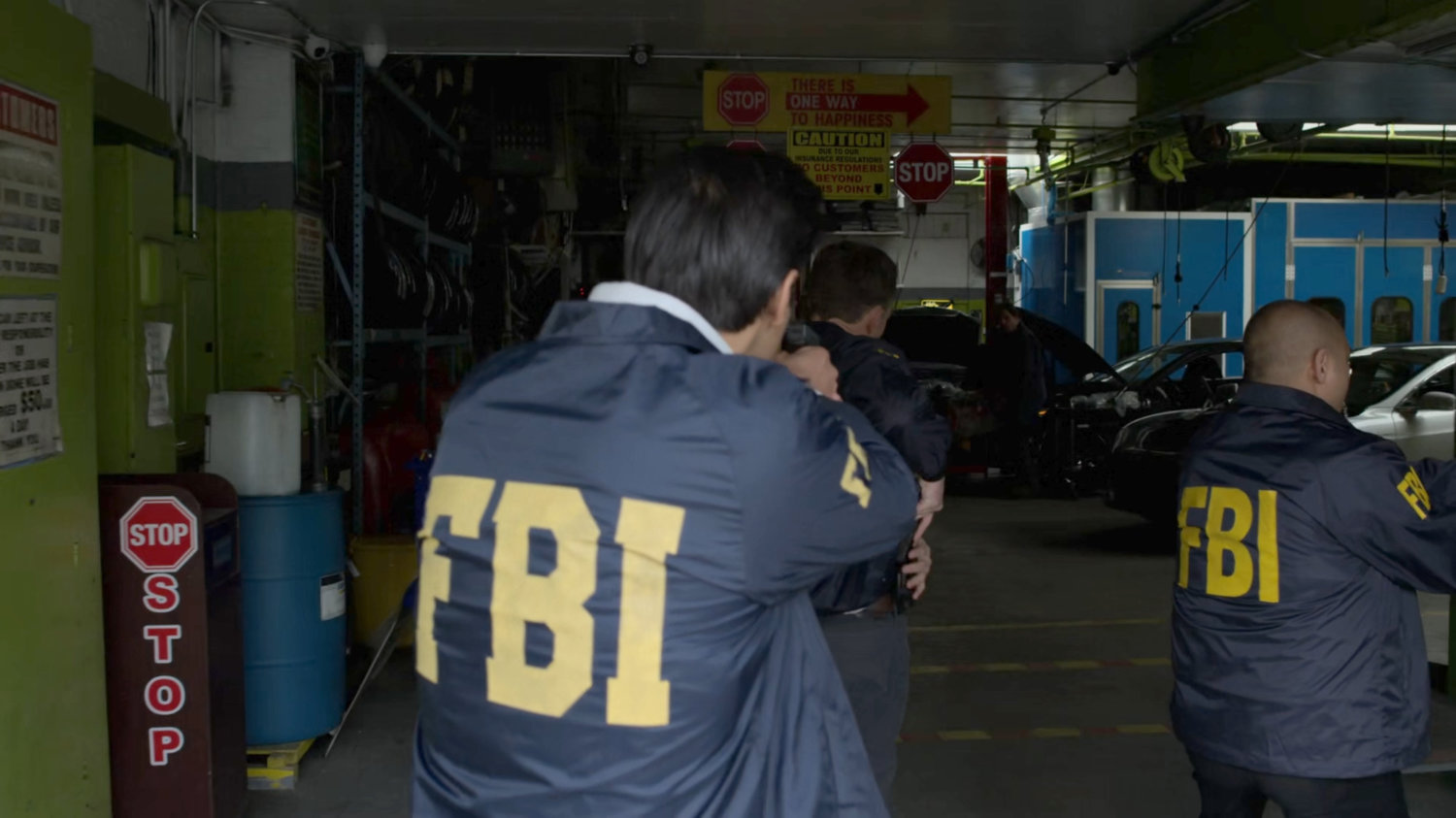 FBI agents raid an auto garage.