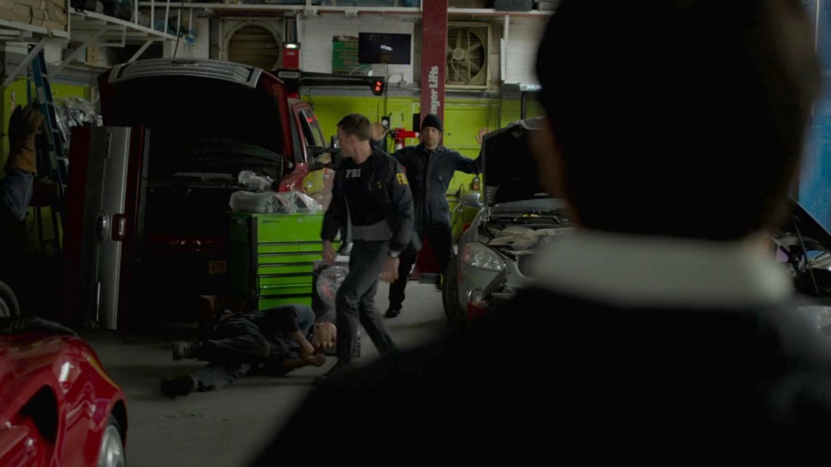 Dex beats a suspect in a raid of an auto garage.